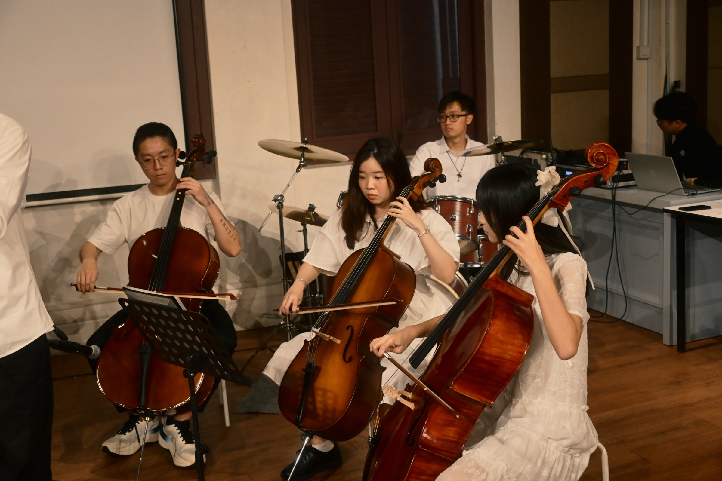 Three cellists and a drummer from Virtuoso Élite performing at the academy's first annual concert